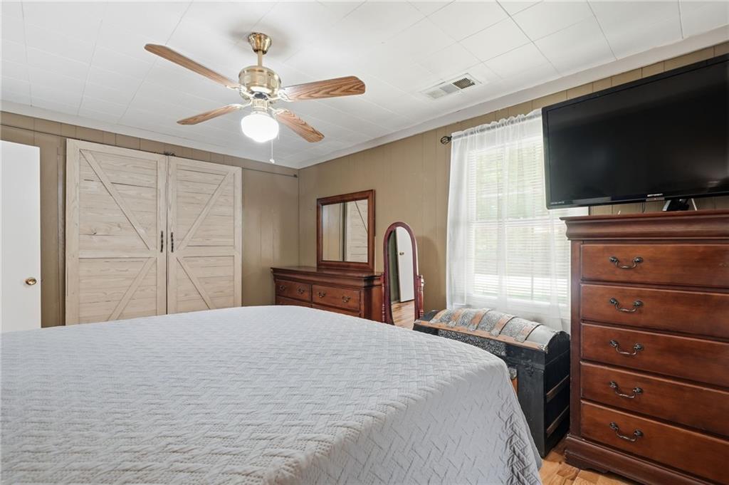 1709 Harrington Road Ball Ground, GA 30107 - Photo 23 of 46 a bedroom with a bed and a flat screen tv
