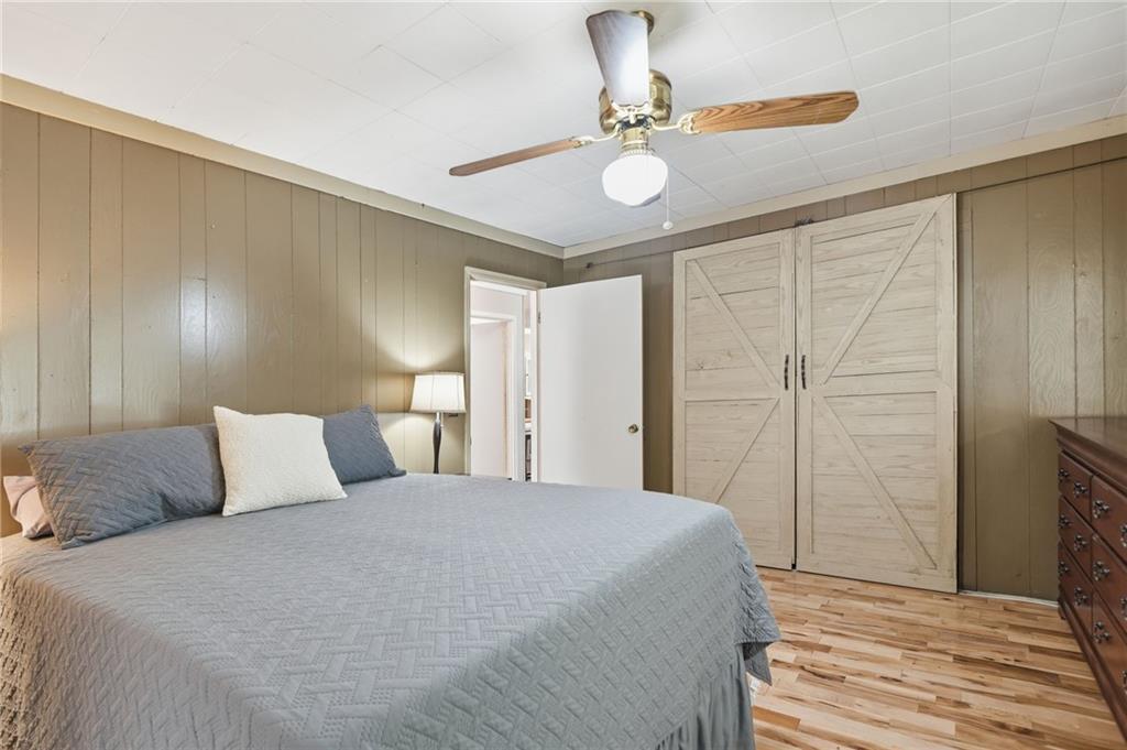 1709 Harrington Road Ball Ground, GA 30107 - Photo 24 of 46 a bedroom with a bed and painting on the wall