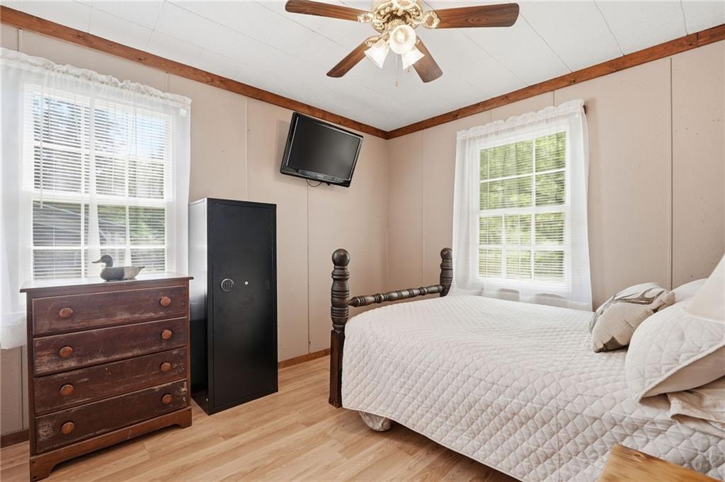 1709 Harrington Road Ball Ground, GA 30107 - Photo 25 of 46 a bedroom with a bed and a flat tv screen on dresser