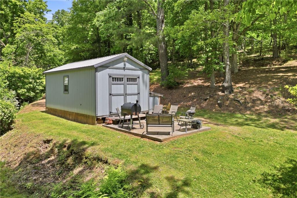1709 Harrington Road Ball Ground, GA 30107 - Photo 28 of 46 a view of a house with backyard and sitting area