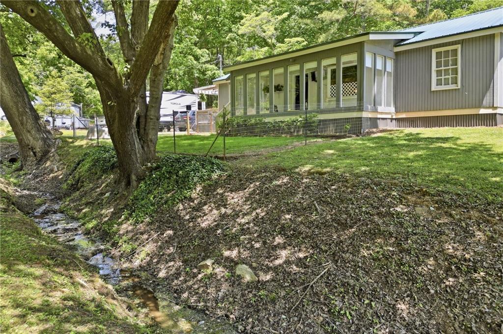 1709 Harrington Road Ball Ground, GA 30107 - Photo 30 of 46 a backyard of a house with garden and deck
