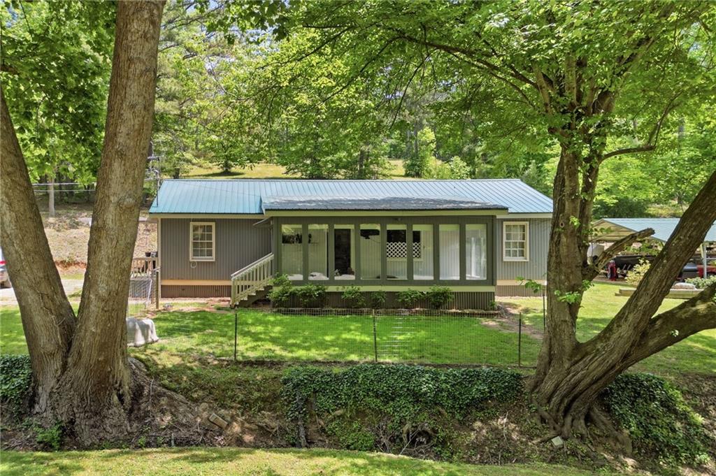 1709 Harrington Road Ball Ground, GA 30107 - Photo 3 of 46 front view of a house with a yard