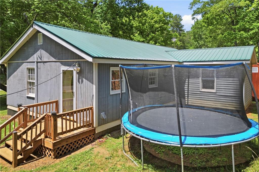1709 Harrington Road Ball Ground, GA 30107 - Photo 32 of 46 a backyard of a house with fountain table and chairs