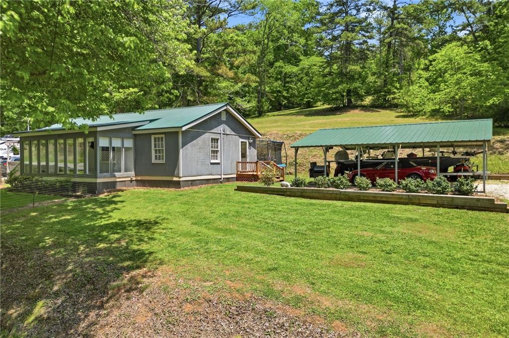 1709 Harrington Road Ball Ground, GA 30107 - Photo 4 of 46 a front view of a house with garden