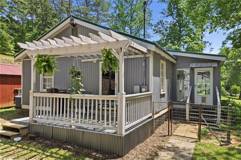1709 Harrington Road Ball Ground, GA 30107 - Photo 6 of 46 a view of a house with a wooden deck and furniture