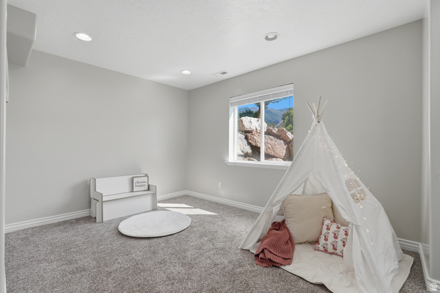 1997 East 600 South Springville, UT 84663 - Photo 46 of 54 Recessed lighting, large window, mountain scenery, gray carpeting, and light gray wall paint