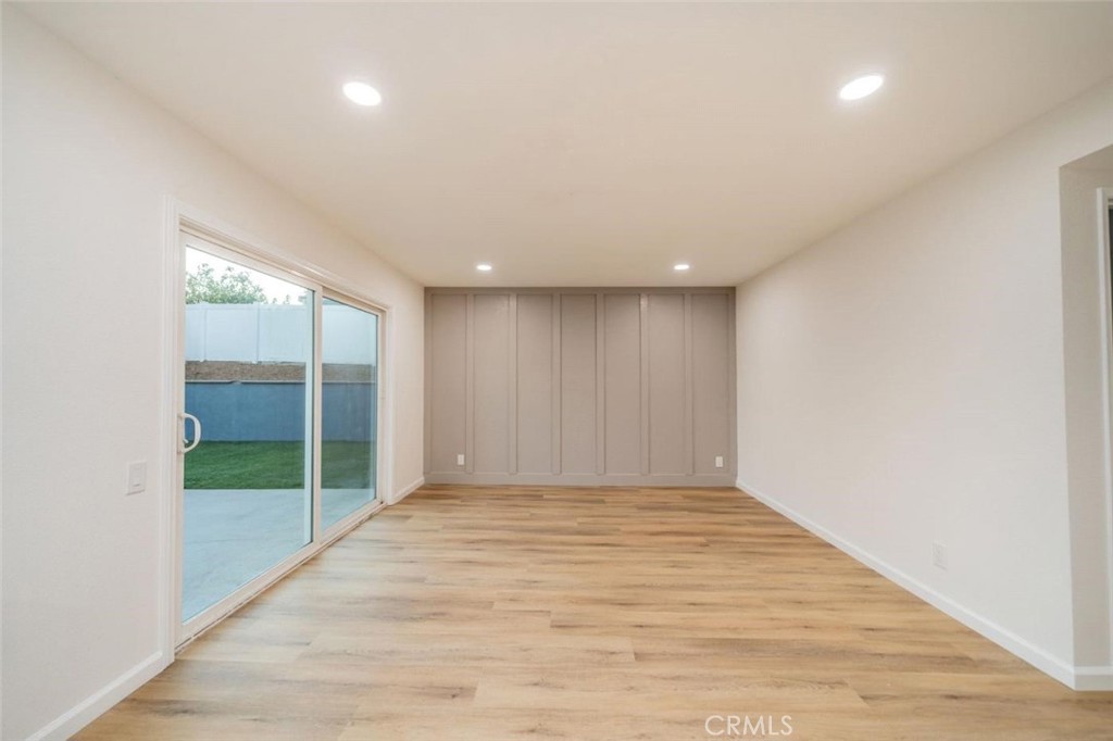 1118 Fallbrook Drive Corona, CA 92878 - Photo 11 of 30 a view of an empty room with wooden floor and a window