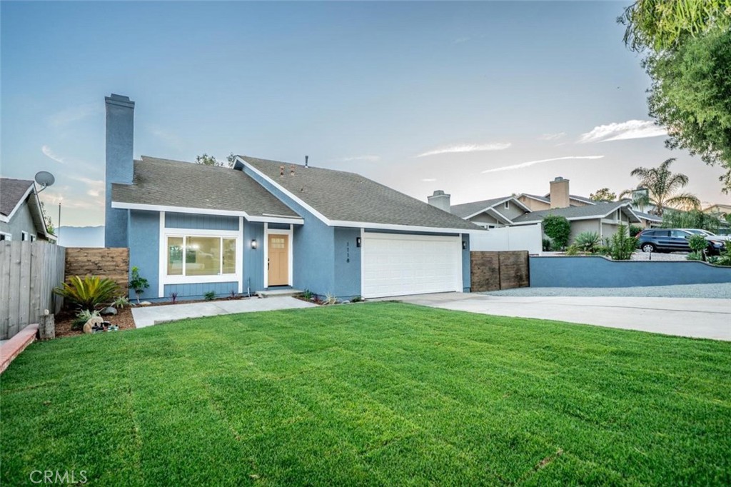 1118 Fallbrook Drive Corona, CA 92878 - Photo 2 of 30 a front view of a house with a yard and garage