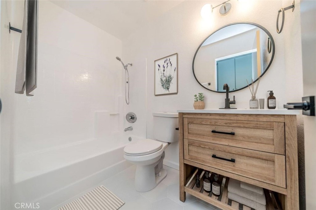 1118 Fallbrook Drive Corona, CA 92878 - Photo 22 of 30 a bathroom with a toilet a sink and a mirror