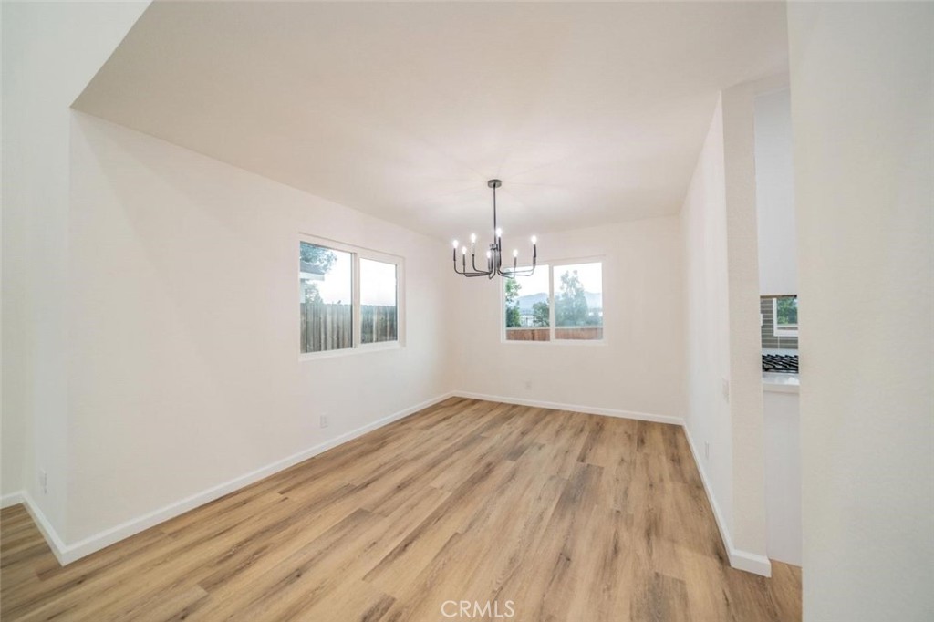 1118 Fallbrook Drive Corona, CA 92878 - Photo 9 of 30 wooden floor in an empty room with a window