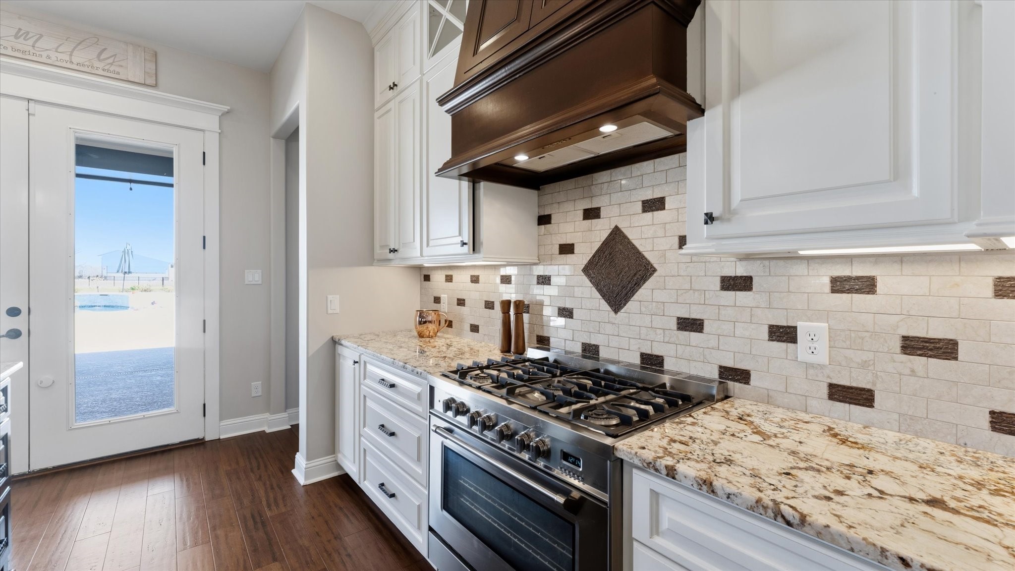 24 Longhorn Loop New Waverly, TX 77358 - Photo 11 of 45 a kitchen with a stove and wooden floor