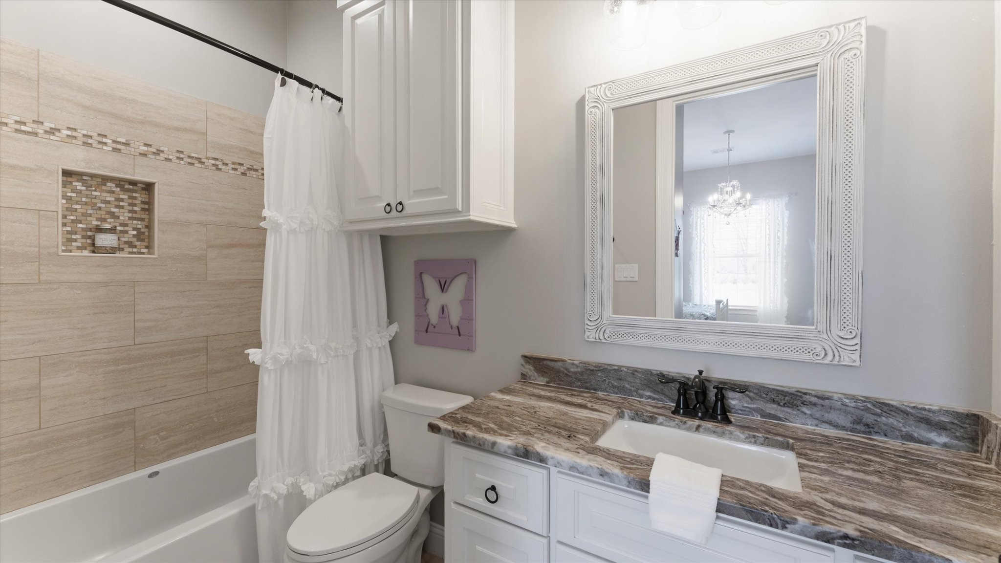 24 Longhorn Loop New Waverly, TX 77358 - Photo 18 of 45 a bathroom with a granite countertop sink toilet mirror vanity and bathtub