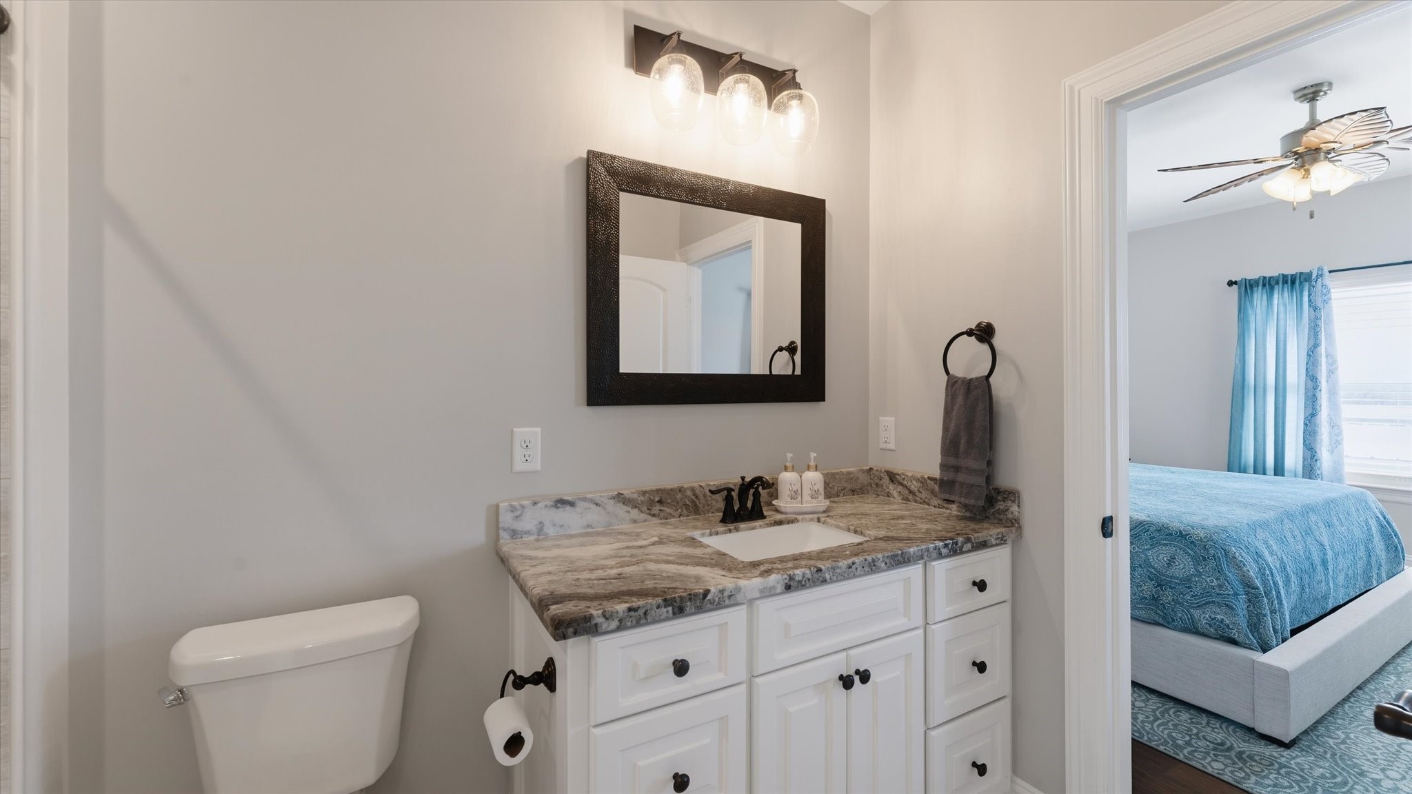 24 Longhorn Loop New Waverly, TX 77358 - Photo 24 of 45 a bathroom with a toilet sink and mirror