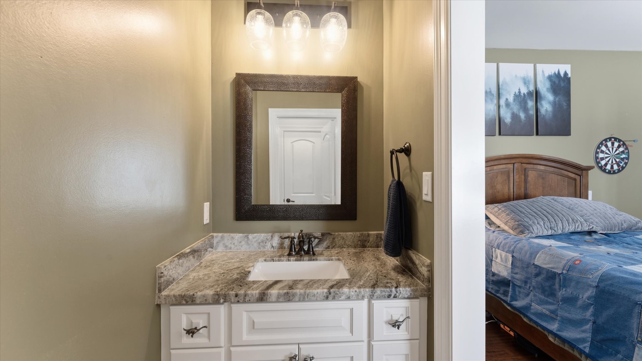 24 Longhorn Loop New Waverly, TX 77358 - Photo 25 of 45 a bathroom with a granite countertop sink and a mirror