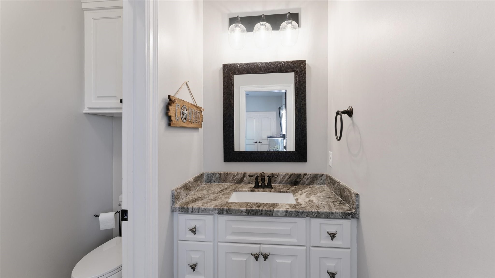 24 Longhorn Loop New Waverly, TX 77358 - Photo 27 of 45 a bathroom with a granite countertop sink and a mirror