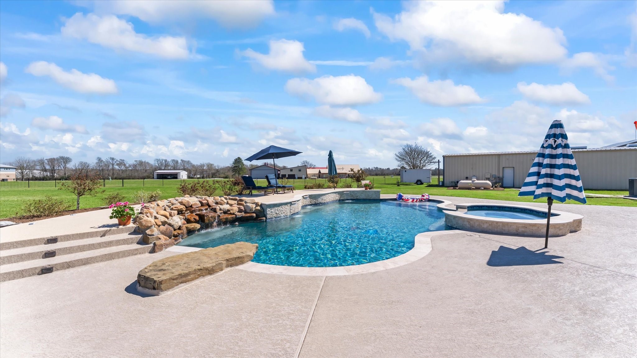 24 Longhorn Loop New Waverly, TX 77358 - Photo 37 of 45 a view of a swimming pool and lounge chairs
