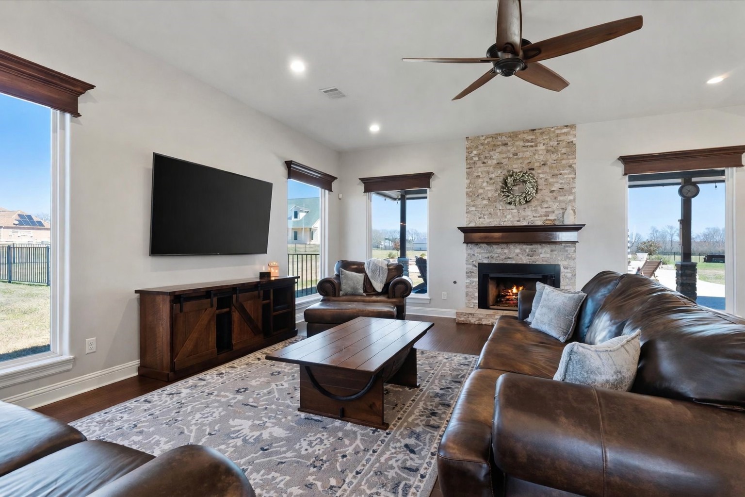 24 Longhorn Loop New Waverly, TX 77358 - Photo 7 of 45 a living room with furniture a flat screen tv and a fireplace