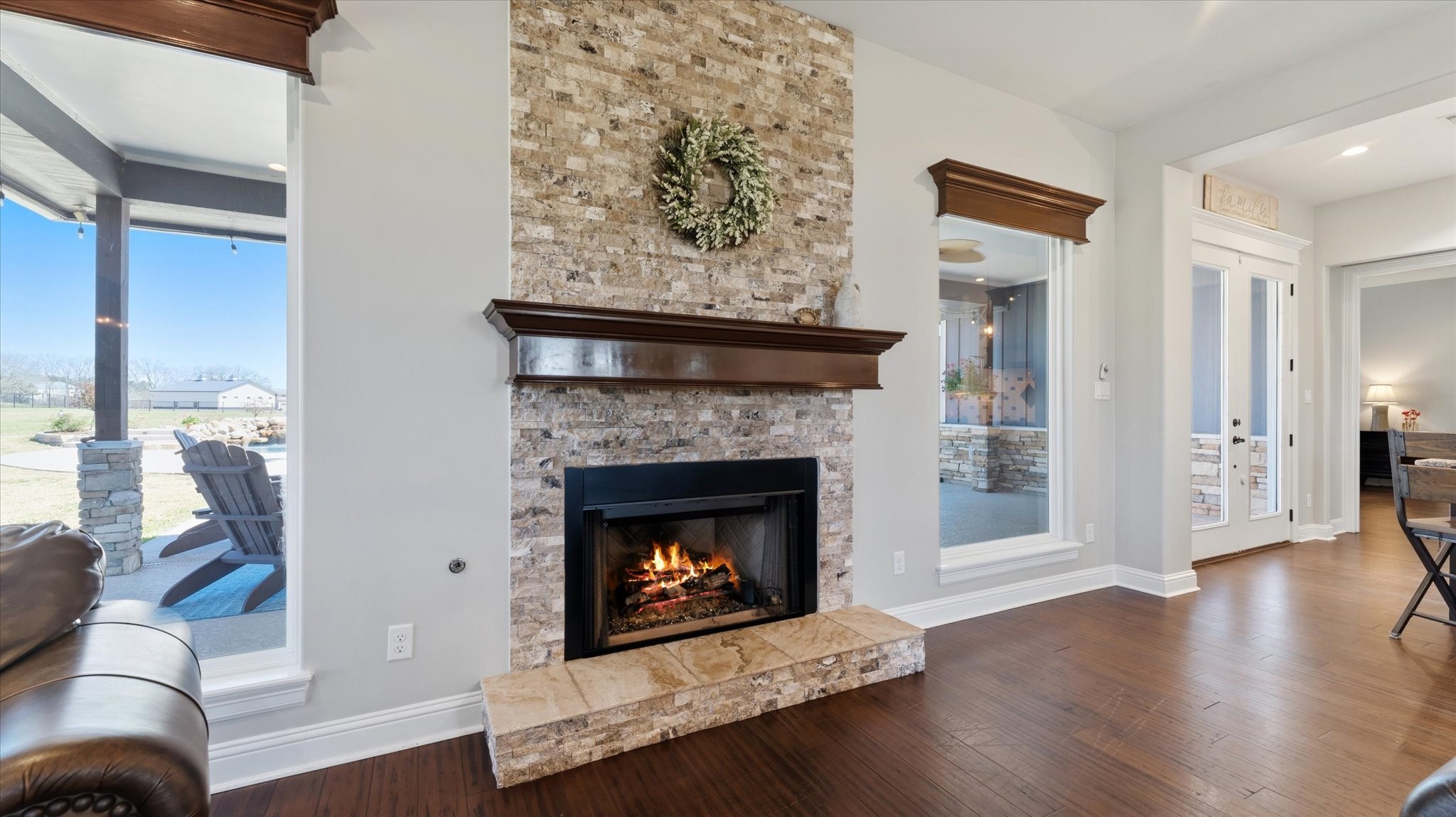 24 Longhorn Loop New Waverly, TX 77358 - Photo 8 of 45 a living room with a fireplace and wooden floor