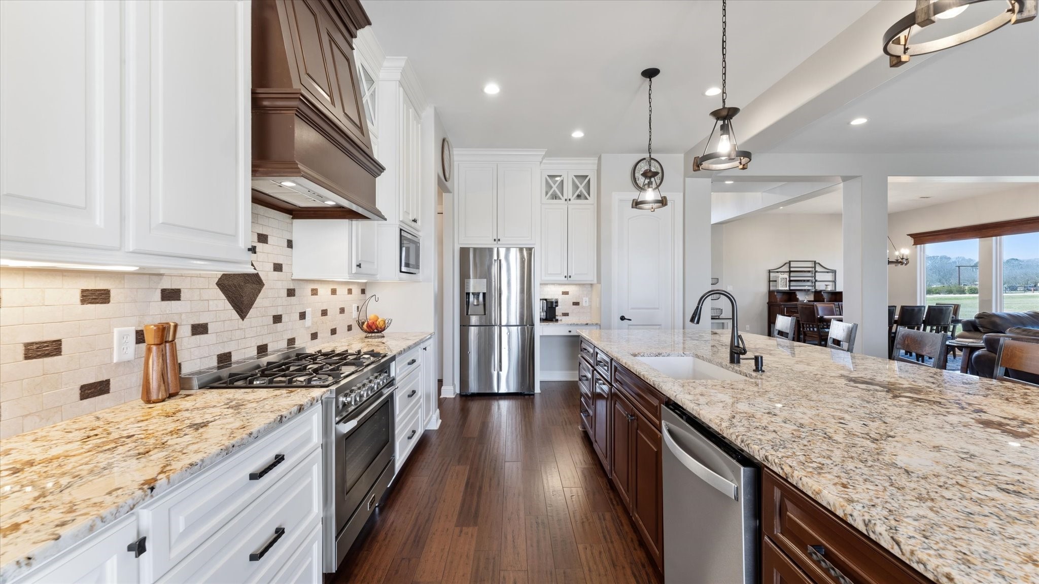 24 Longhorn Loop New Waverly, TX 77358 - Photo 10 of 45 a large kitchen with stainless steel appliances granite countertop plenty wooden cabinets counter space a sink and wooden floor