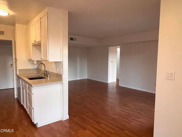 a kitchen with granite countertop a sink and a stove top oven