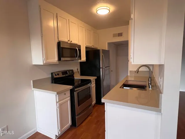 a kitchen with a stove microwave and refrigerator