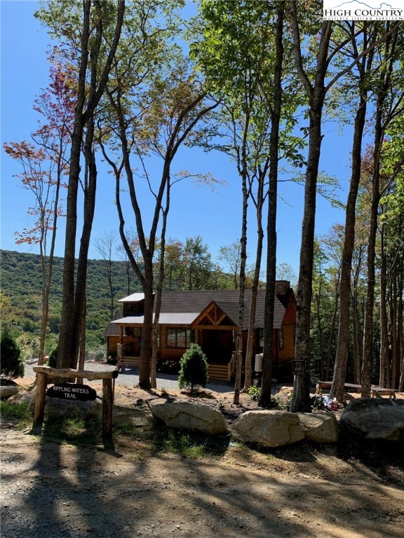 479 Rippling Waters Trail Banner Elk, NC 28604 - Photo 1 of 46 a view of a lake with couches and trees