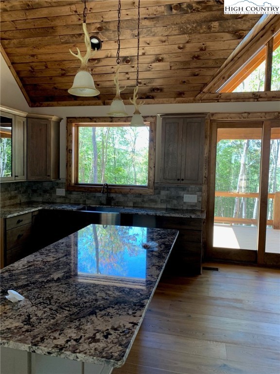 479 Rippling Waters Trail Banner Elk, NC 28604 - Photo 17 of 46 a kitchen with a wooden floor and a counter top space