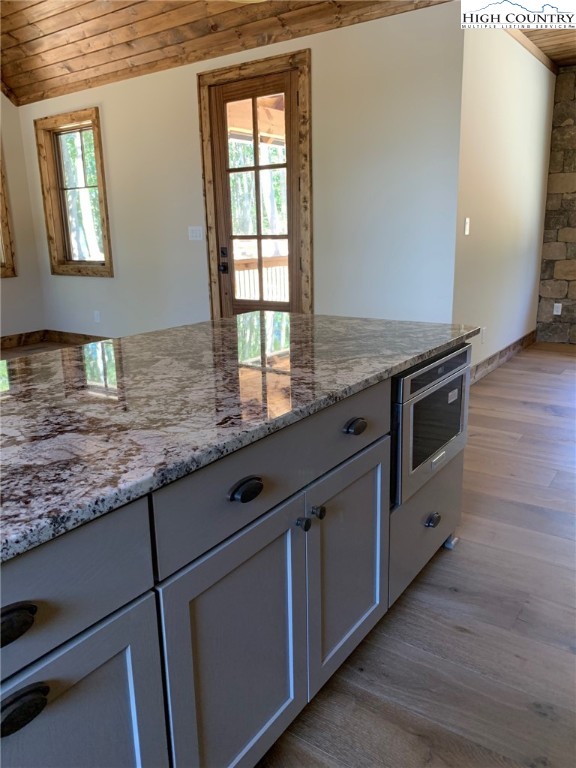 479 Rippling Waters Trail Banner Elk, NC 28604 - Photo 18 of 46 a kitchen with granite countertop cabinets stainless steel appliances a sink and a window