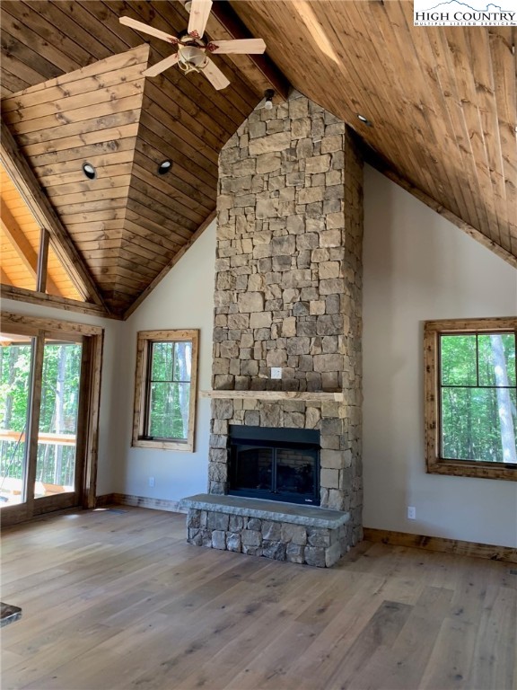 479 Rippling Waters Trail Banner Elk, NC 28604 - Photo 10 of 46 an empty room with wooden floor fireplace and windows