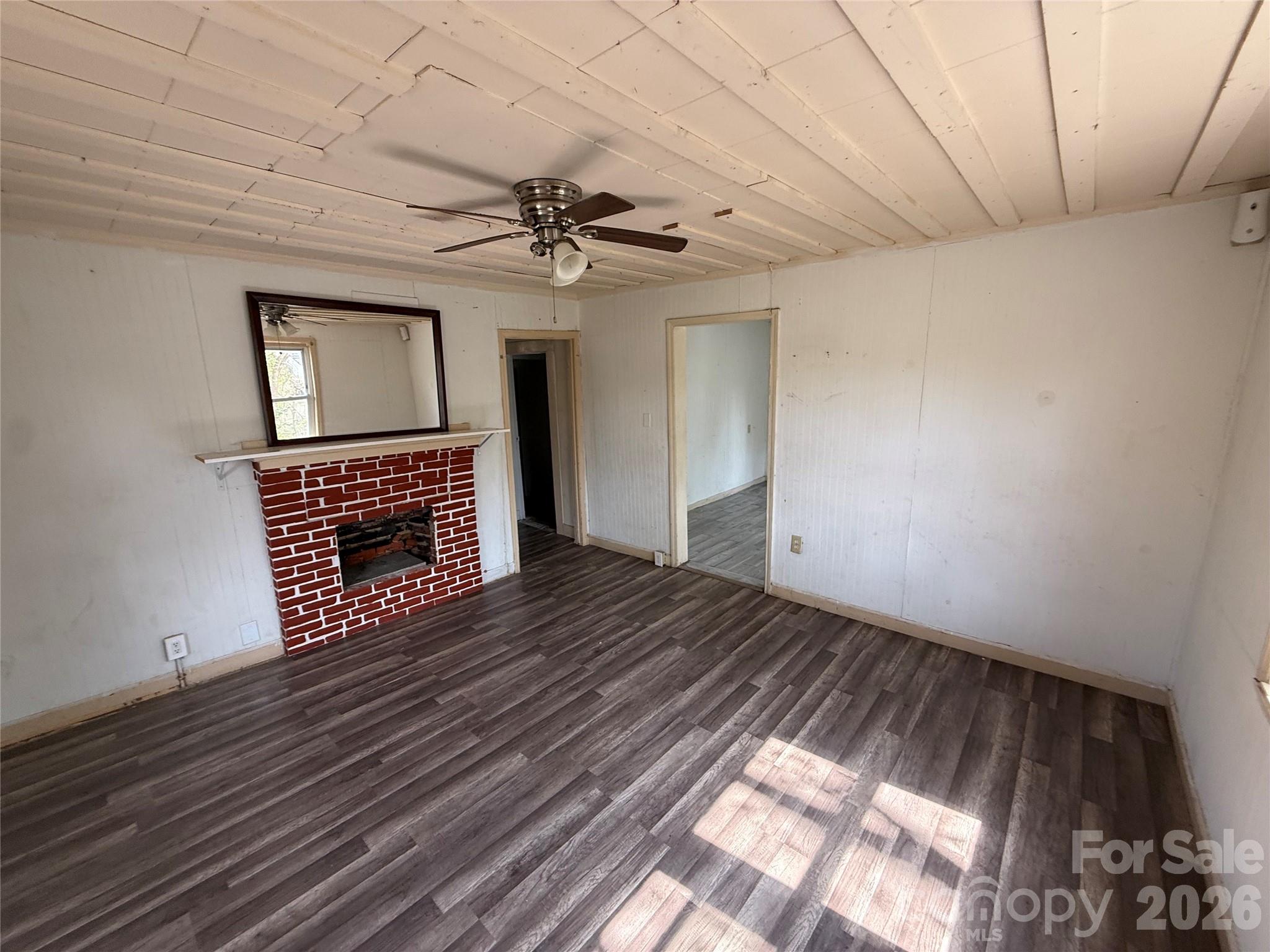 965 13th Street Lancaster, SC 29720 - Photo 15 of 17 a view of an empty room with wooden floor fireplace and a window