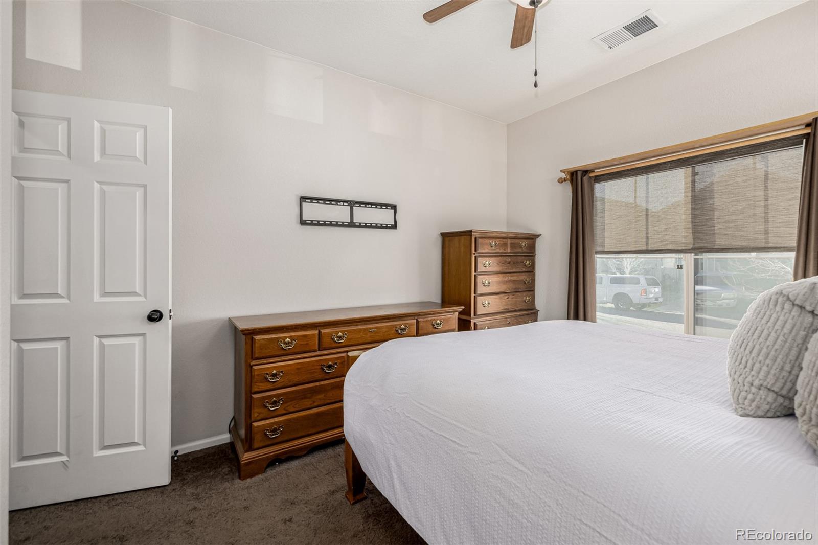 5568 Ceylon Street Denver, CO 80249 - Photo 21 of 43 a bedroom with a bed and a window