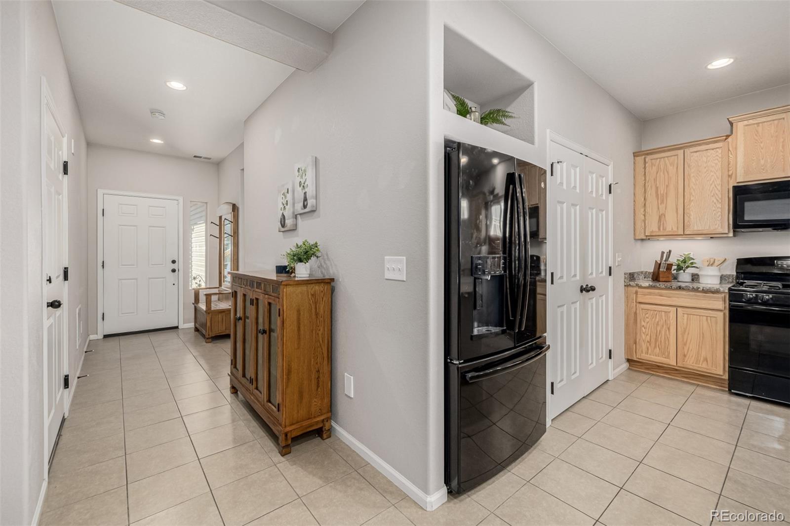 5568 Ceylon Street Denver, CO 80249 - Photo 24 of 43 a kitchen with stainless steel appliances granite countertop a refrigerator and a stove