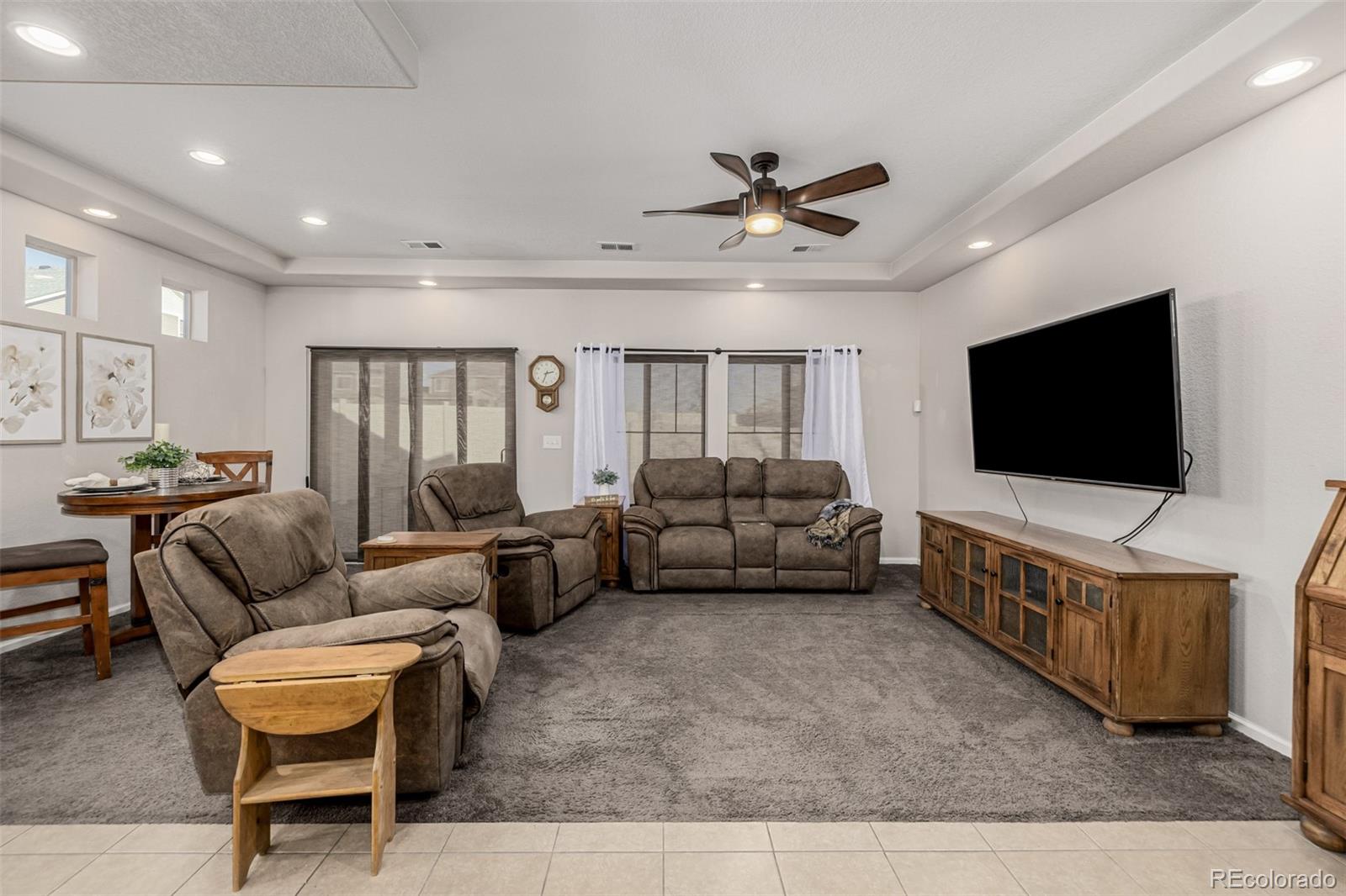 5568 Ceylon Street Denver, CO 80249 - Photo 3 of 43 a living room with furniture and a flat screen tv