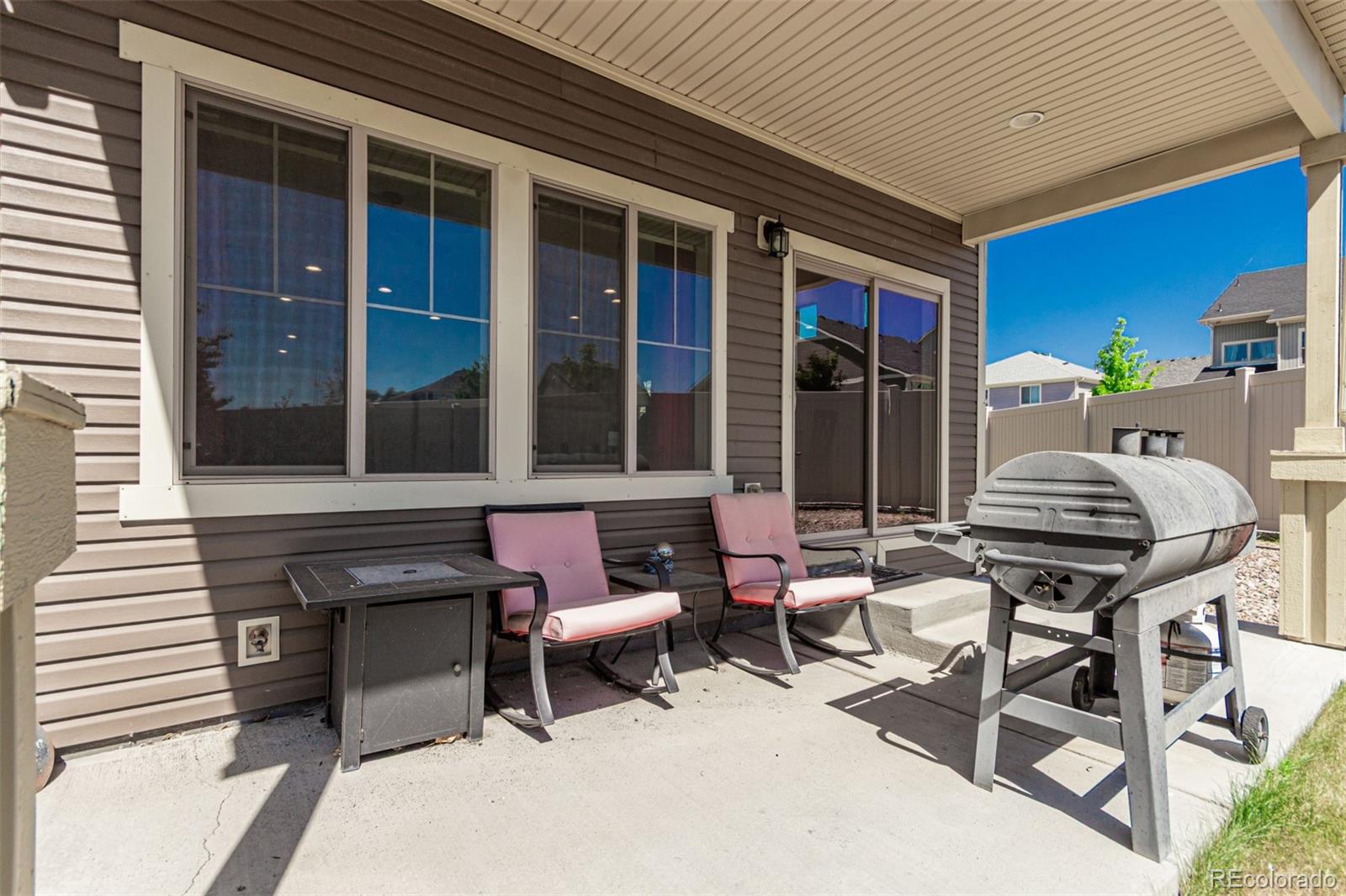 5568 Ceylon Street Denver, CO 80249 - Photo 34 of 43 a view of a patio with table and chairs and floor to ceiling window