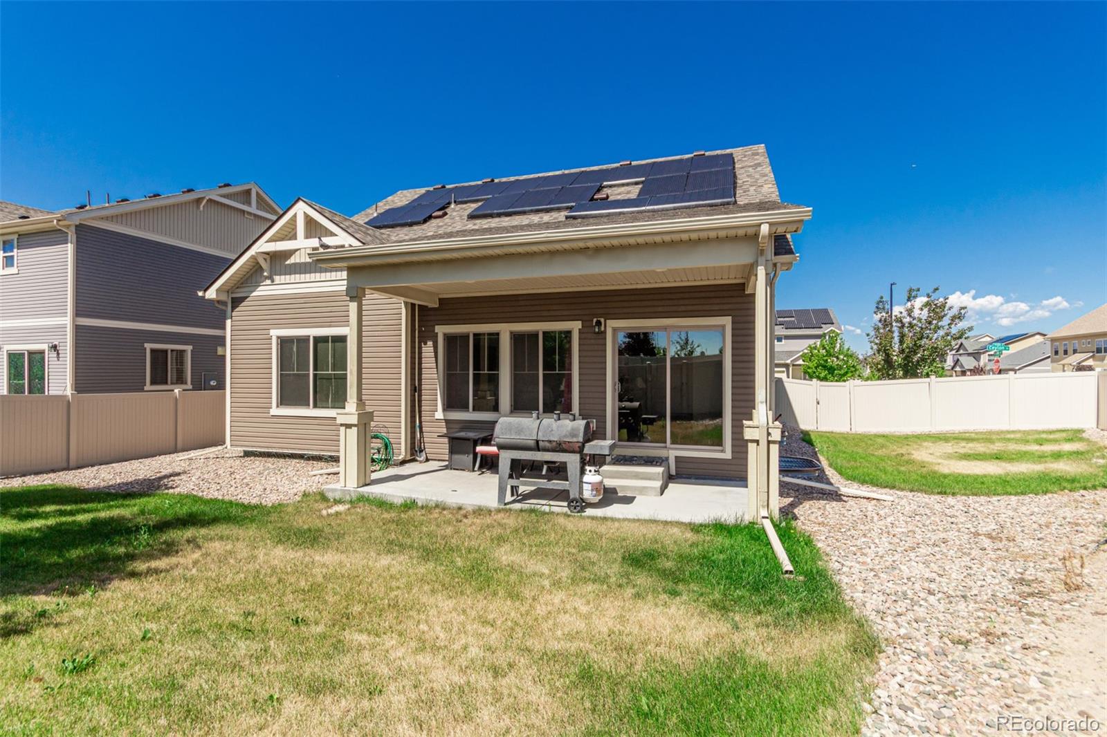 5568 Ceylon Street Denver, CO 80249 - Photo 35 of 43 a view of a house with a yard porch and sitting area