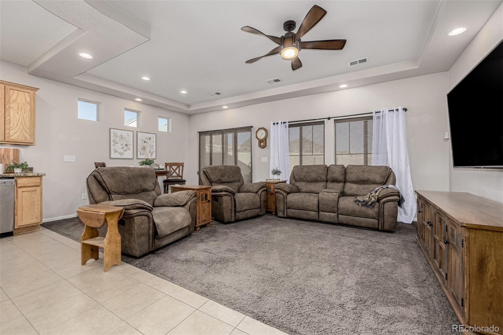5568 Ceylon Street Denver, CO 80249 - Photo 4 of 43 a living room with furniture and a flat screen tv