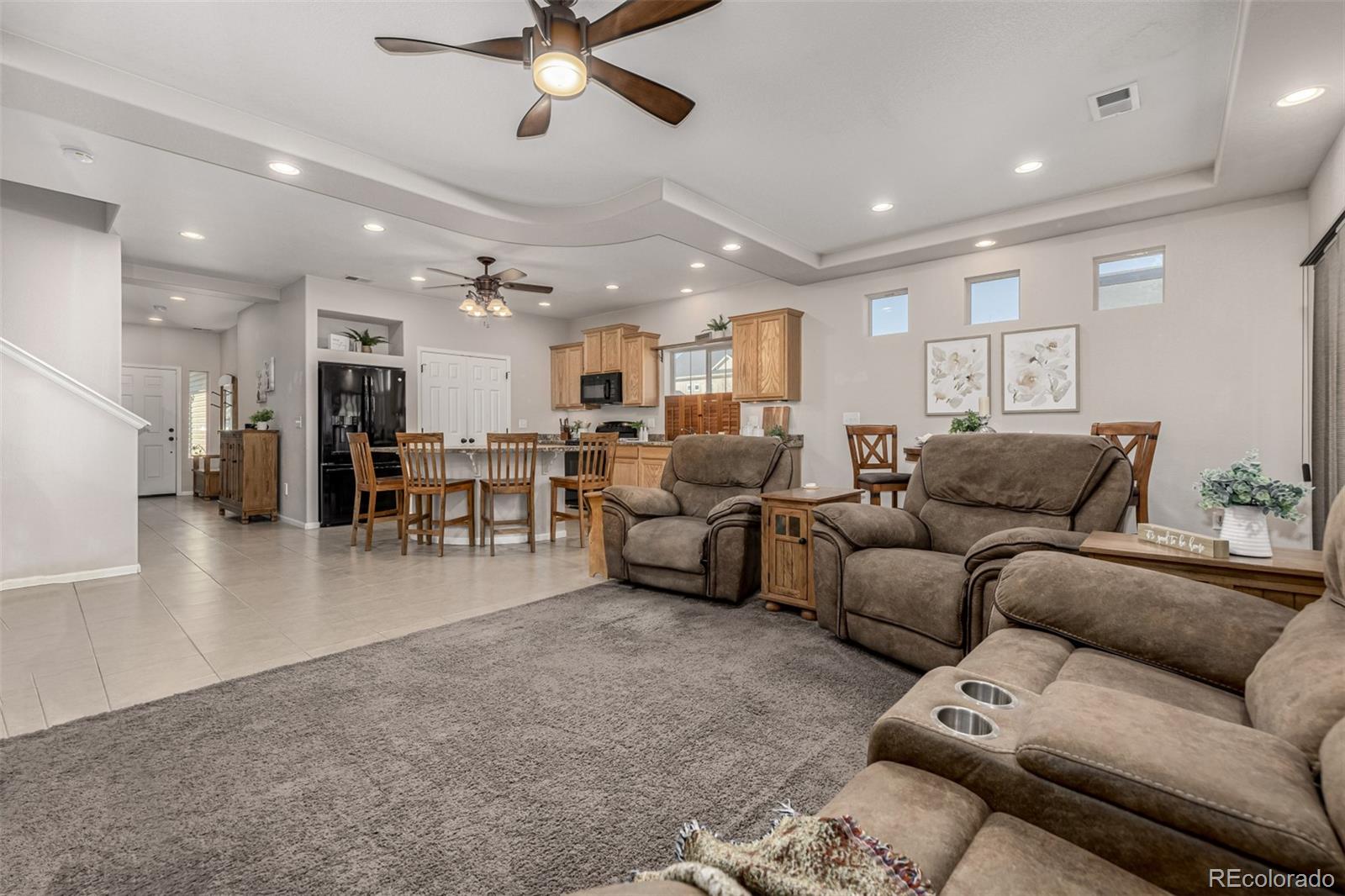 5568 Ceylon Street Denver, CO 80249 - Photo 5 of 43 a living room with furniture and kitchen view