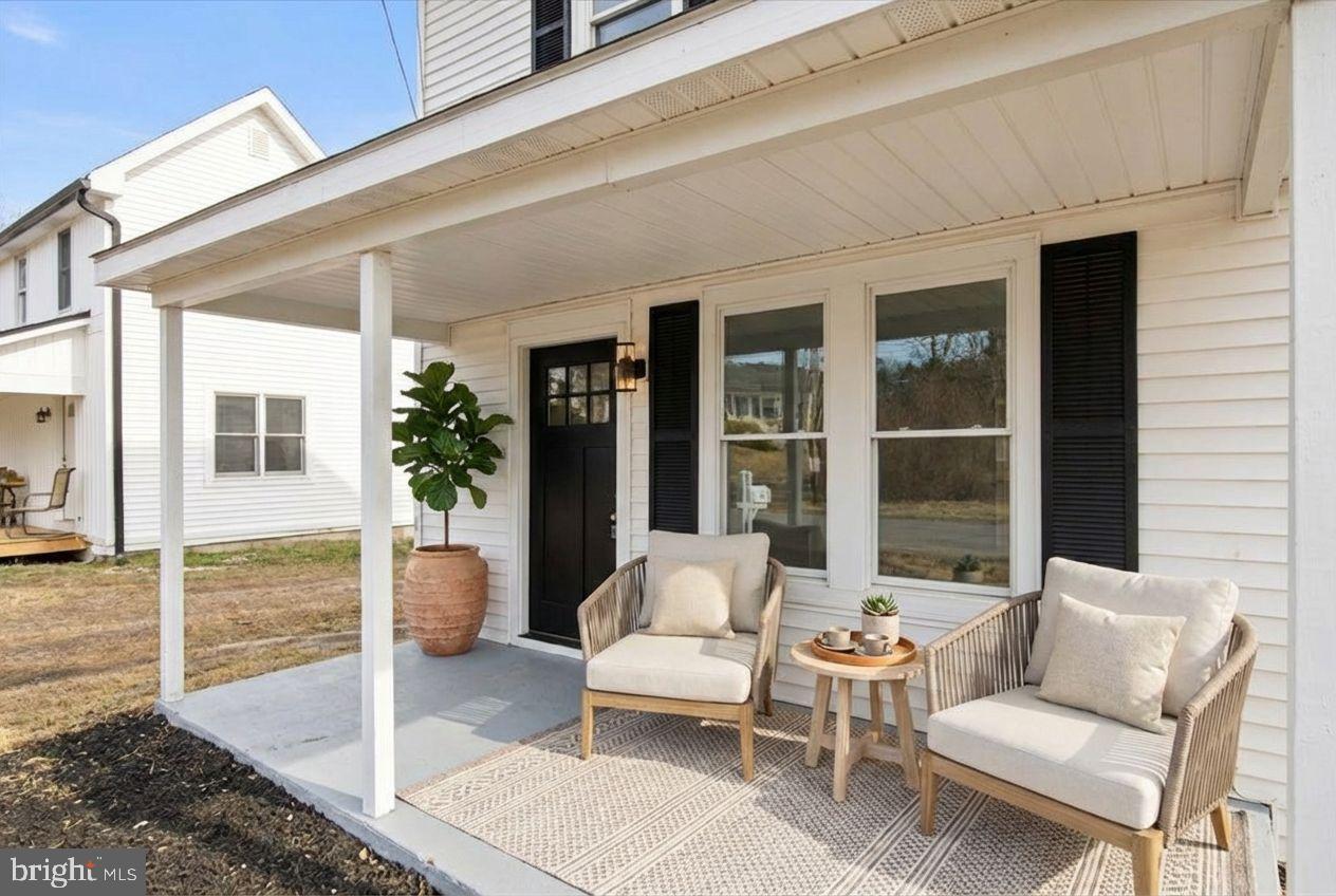 221 Denton Road Federalsburg, MD 21632 - Photo 14 of 33 a balcony with furniture and a potted plant