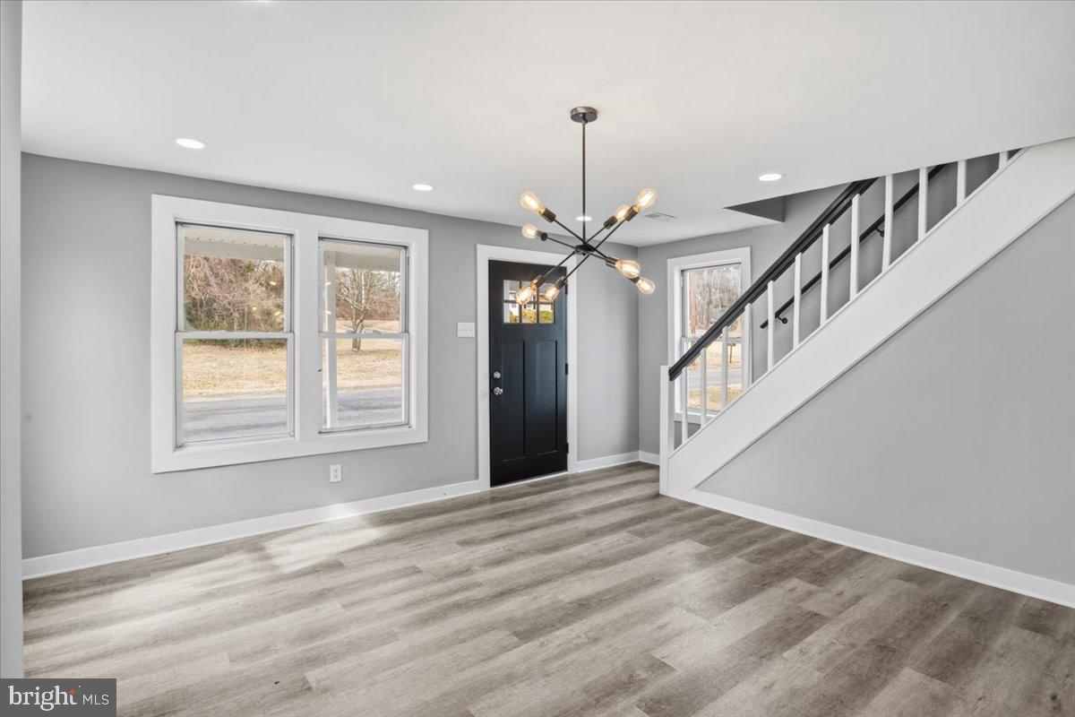 221 Denton Road Federalsburg, MD 21632 - Photo 18 of 33 a view of an empty room with wooden floor and a window