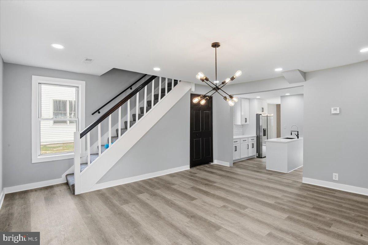 221 Denton Road Federalsburg, MD 21632 - Photo 19 of 33 a view of an empty room with wooden floor and stairs