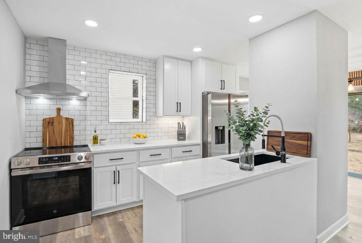 221 Denton Road Federalsburg, MD 21632 - Photo 2 of 33 a kitchen with a sink a stove and cabinets