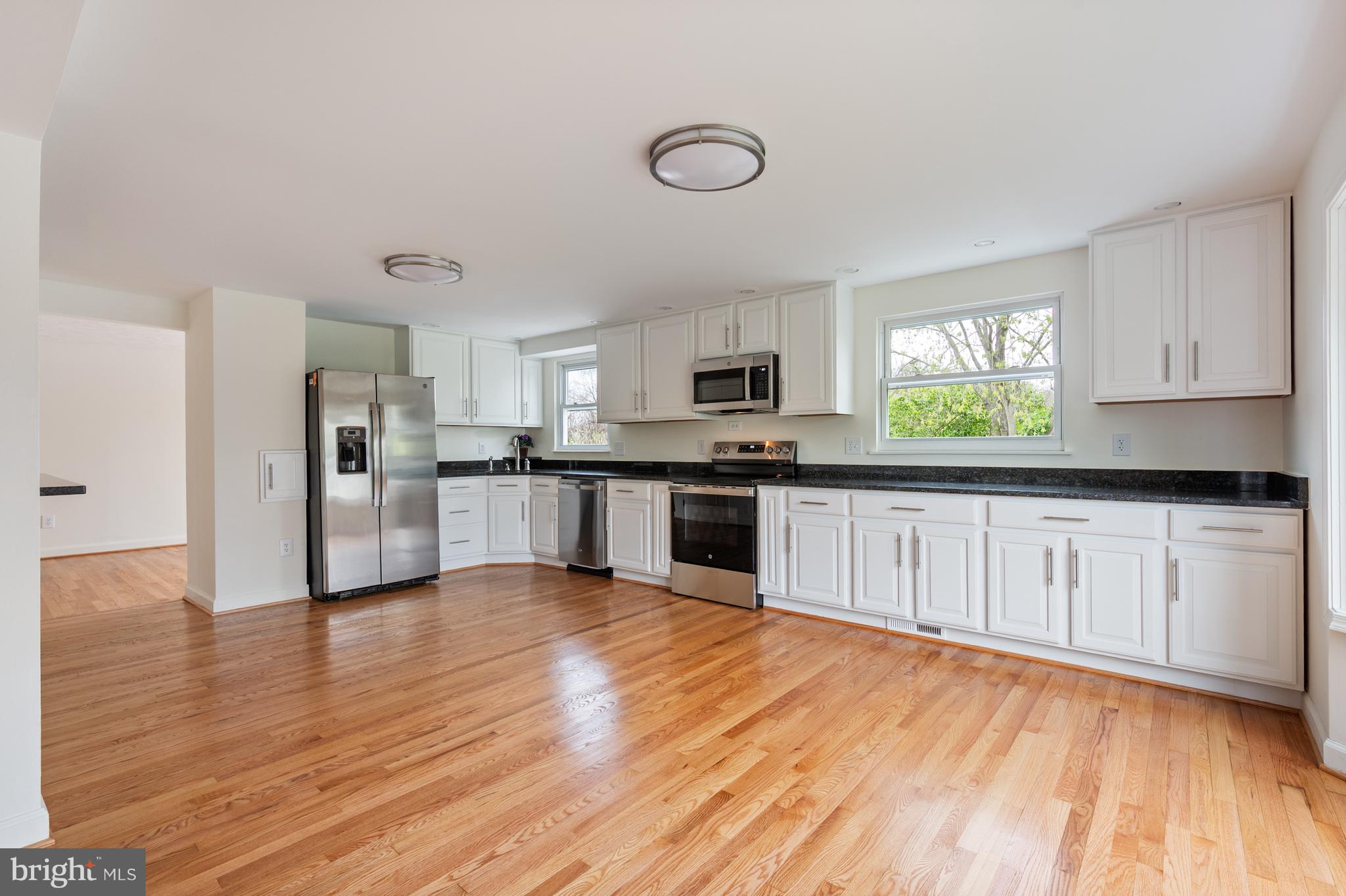 4417 Cub Run Road Chantilly, VA 20151 - Photo 13 of 57 a kitchen with granite countertop a stove top oven sink and cabinets