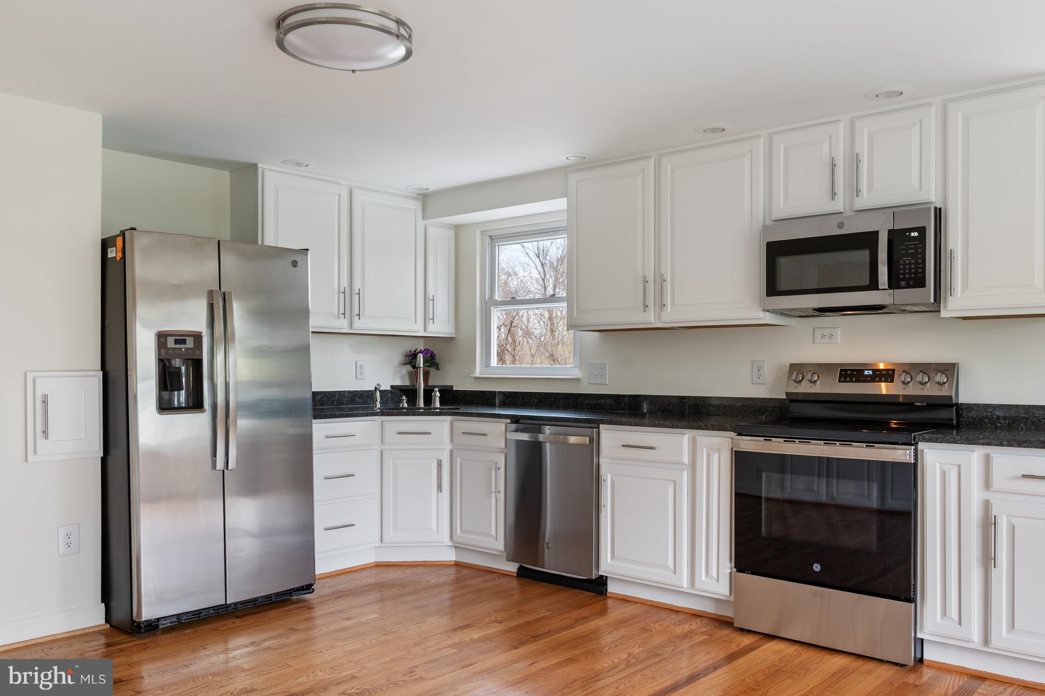 4417 Cub Run Road Chantilly, VA 20151 - Photo 14 of 57 a kitchen with cabinets stainless steel appliances and wooden floor