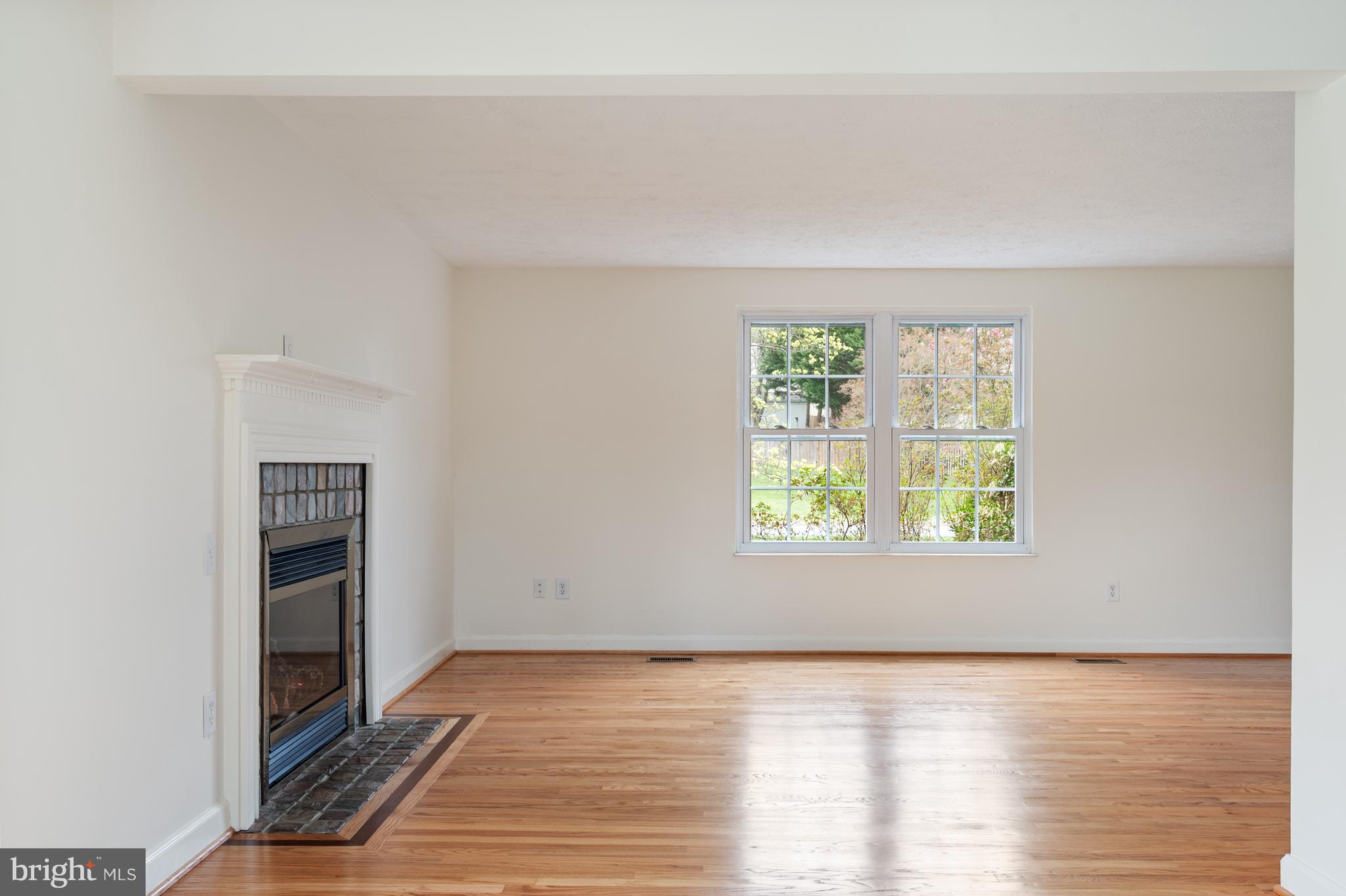 4417 Cub Run Road Chantilly, VA 20151 - Photo 18 of 57 a view of an empty room with wooden floor and a window