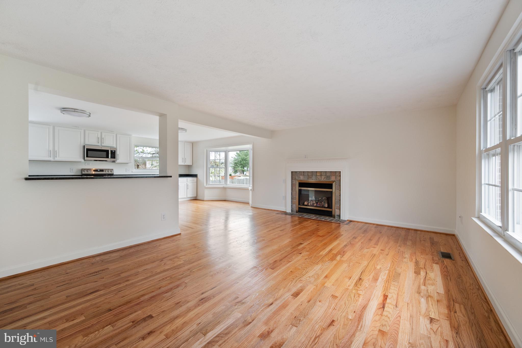 4417 Cub Run Road Chantilly, VA 20151 - Photo 20 of 57 a view of a kitchen and an empty room with wooden floor and a window