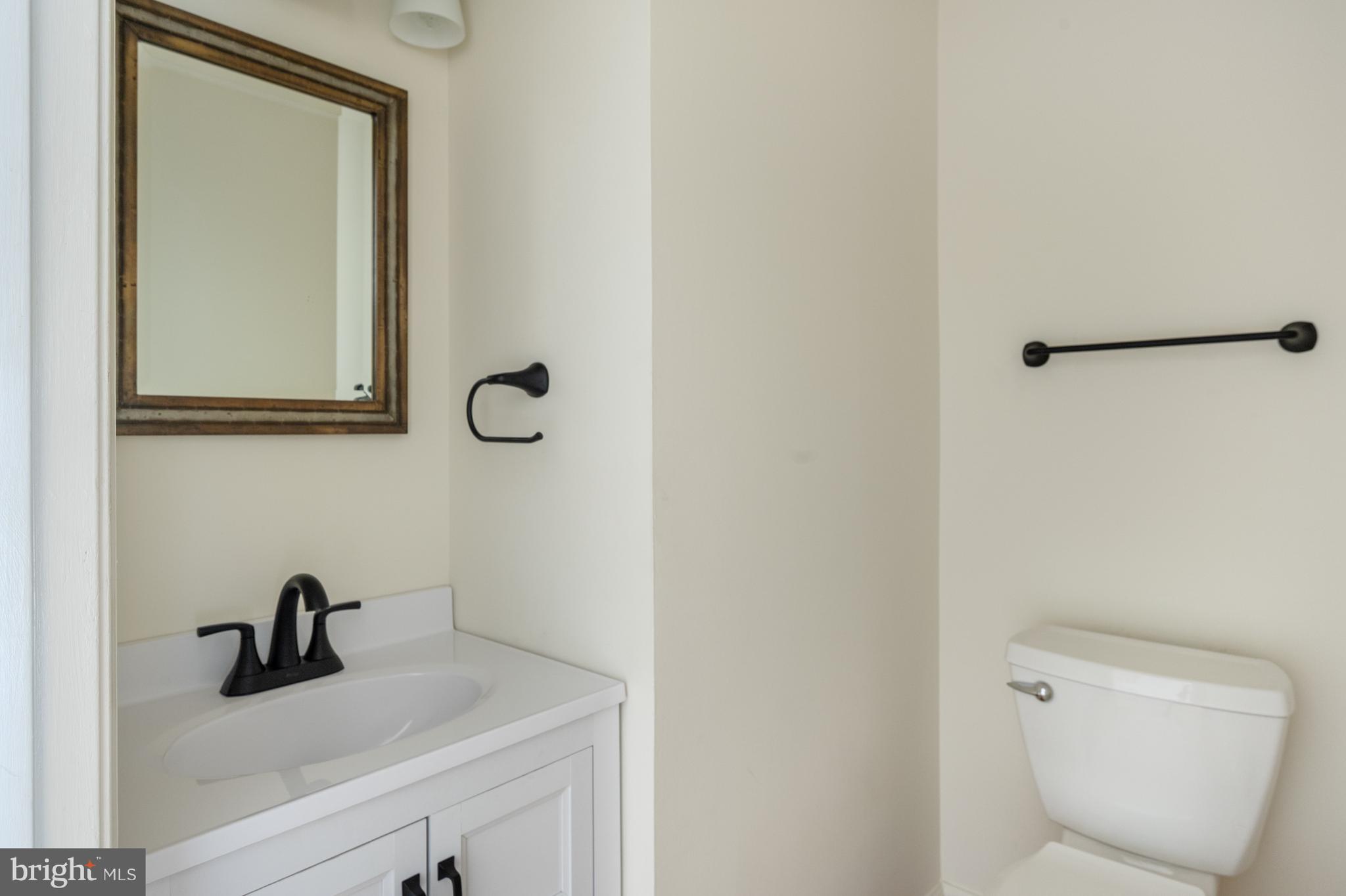 4417 Cub Run Road Chantilly, VA 20151 - Photo 21 of 57 a bathroom with a toilet sink and mirror