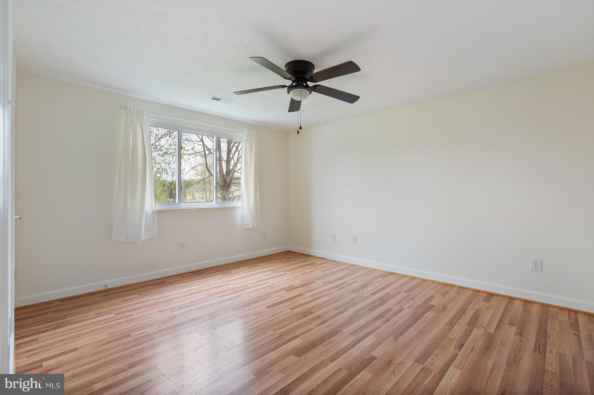 4417 Cub Run Road Chantilly, VA 20151 - Photo 24 of 57 an empty room with wooden floor fan and windows