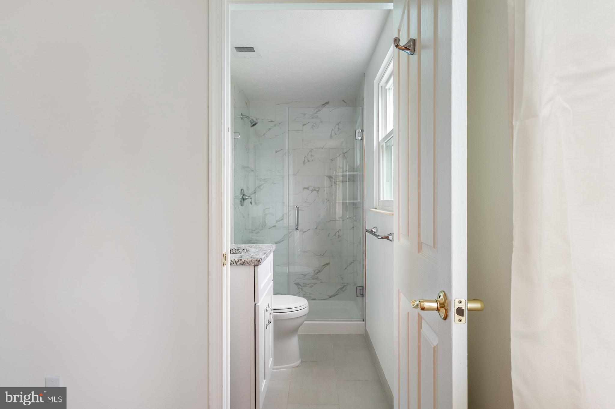 4417 Cub Run Road Chantilly, VA 20151 - Photo 26 of 57 a bathroom with a granite countertop toilet