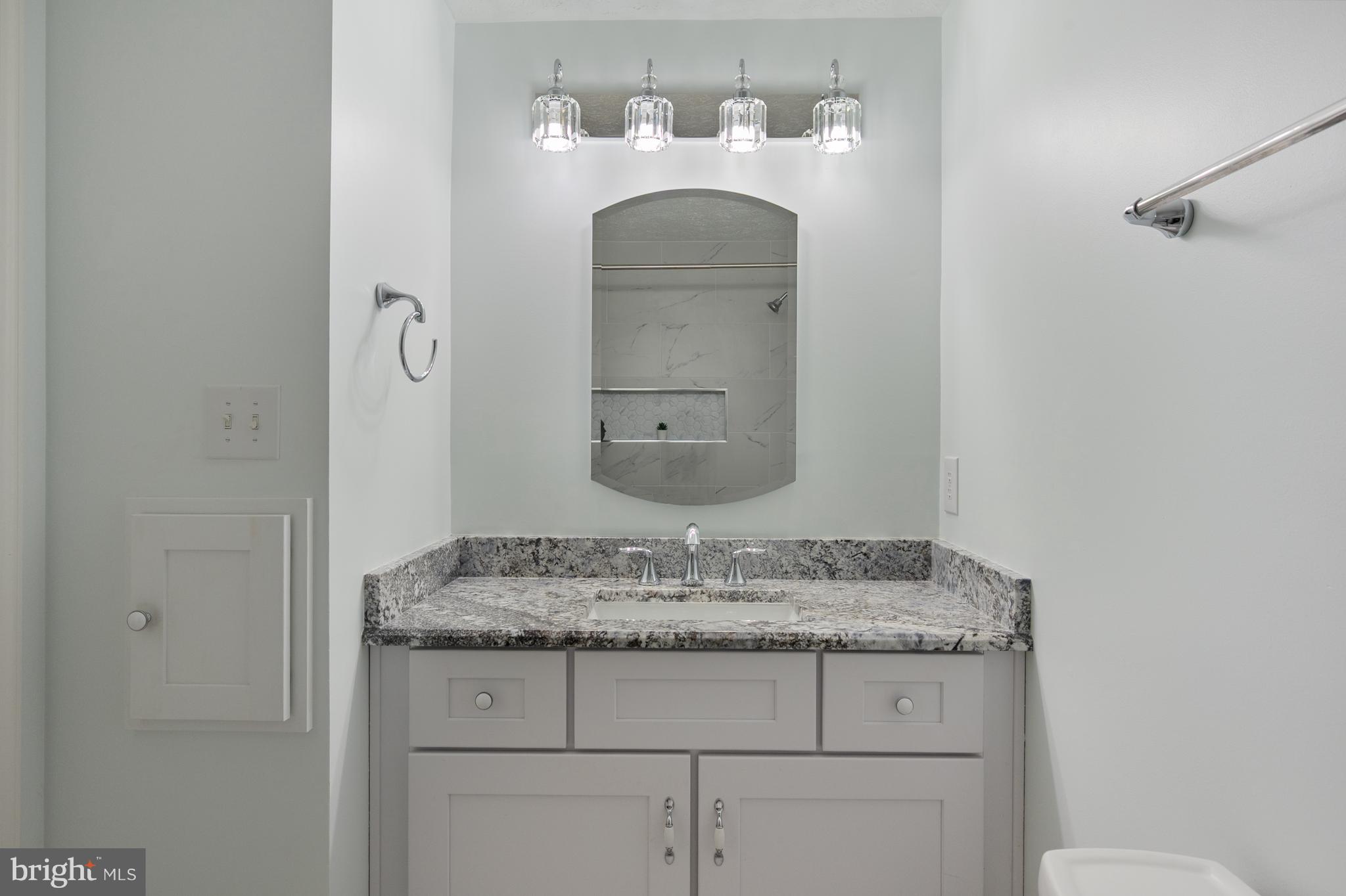 4417 Cub Run Road Chantilly, VA 20151 - Photo 31 of 57 a bathroom with a granite countertop sink and a mirror
