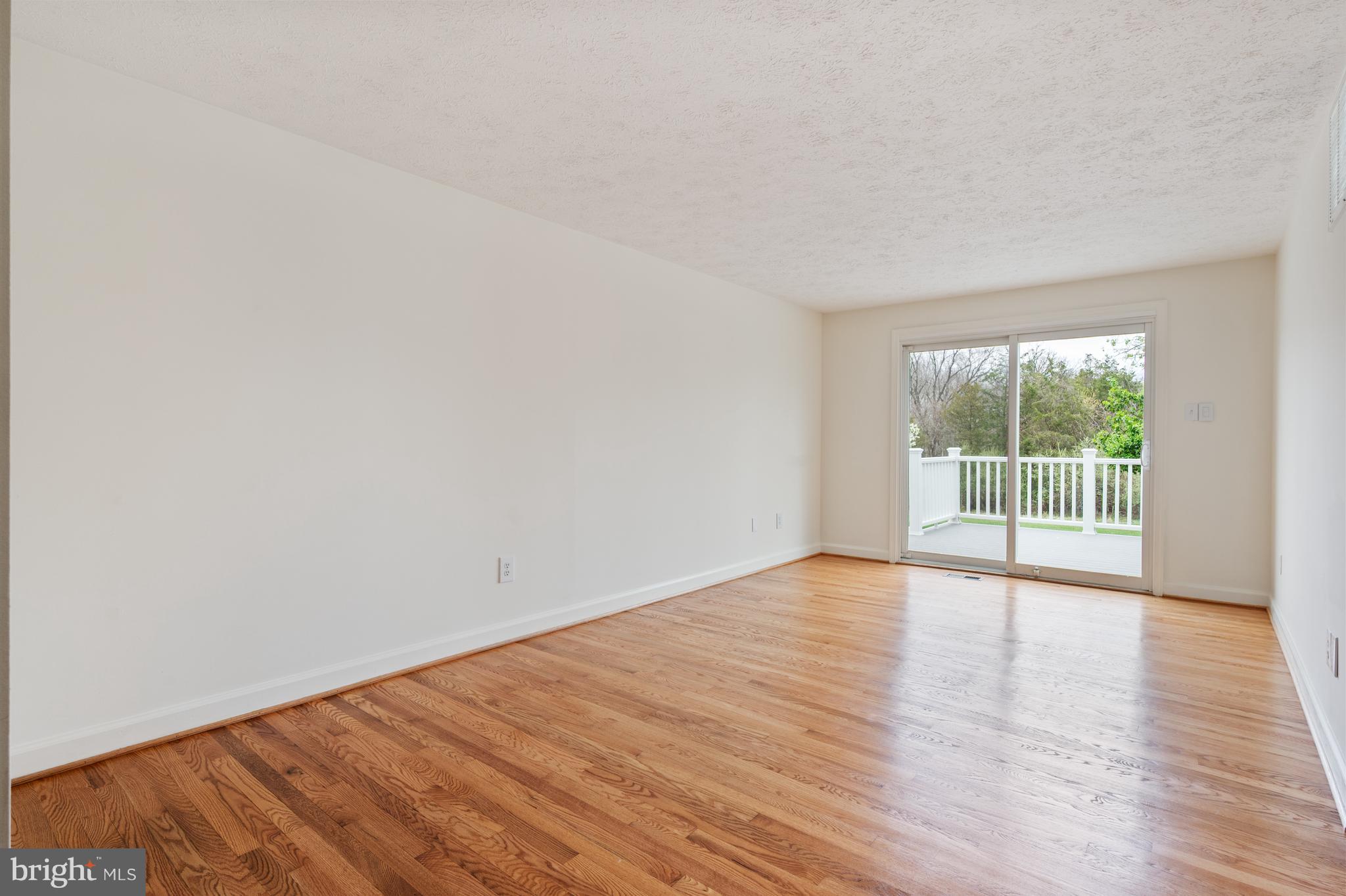 4417 Cub Run Road Chantilly, VA 20151 - Photo 9 of 57 a view of an empty room with wooden floor and a window
